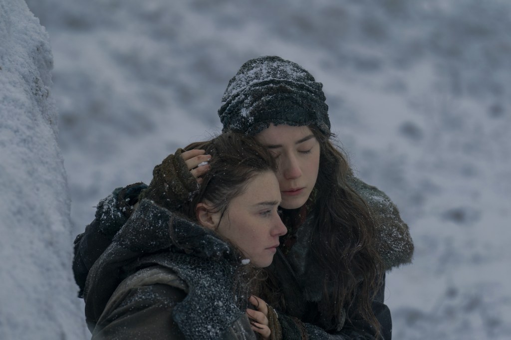 Emma Canning as Tula Harkonnen hugging her sister Valya Harkonnen (Jessica Barden) in a snowy field in Dune: Prophecy.