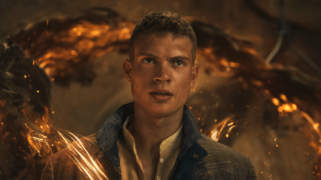 A promotional still from season 3 of The Wheel of time featuring Rand Al'Thor (Josha Stradowski) channeling the one power (fiery and dark swirls around him) with a determined look on his face.