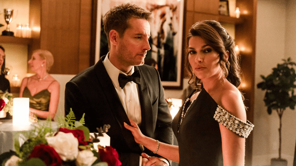 A still from TV show Tracker season one featuring a man (Justin Hartley as Colton Shaw) in a tuxedo looking at a woman (Sofia Pernas as Billie Matalon) wearing a cocktail dress holding the man's jacket but looking in the distance. The background suggest a fancy party.