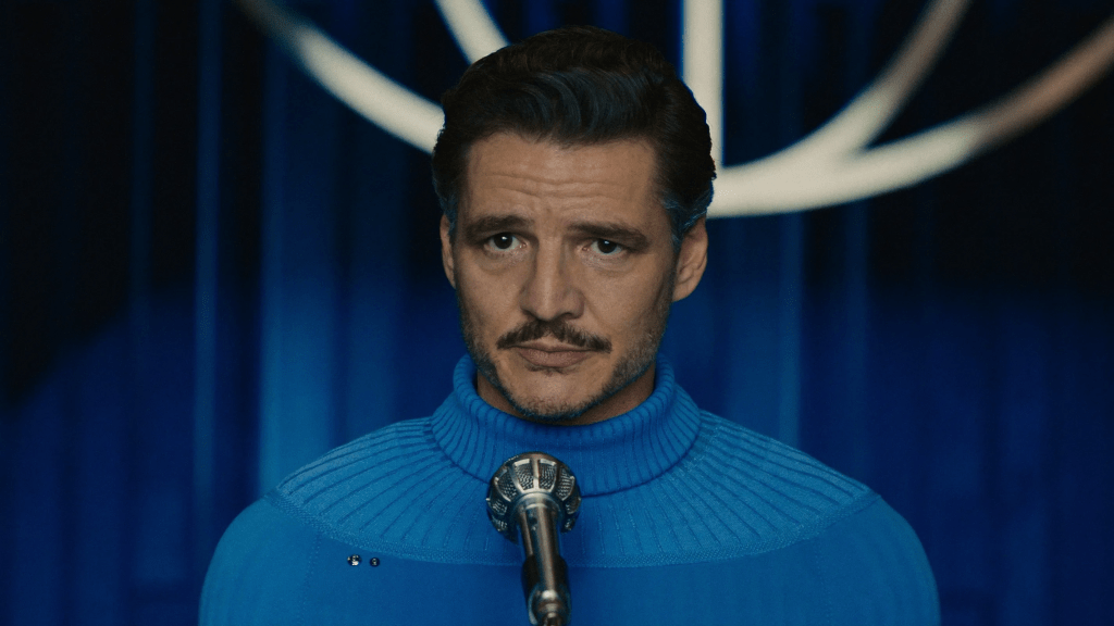 Still from The Fantastic Four: First Steps movie featuring Pedro Pascal as Reed Richards in front of microphone, looking concerned.