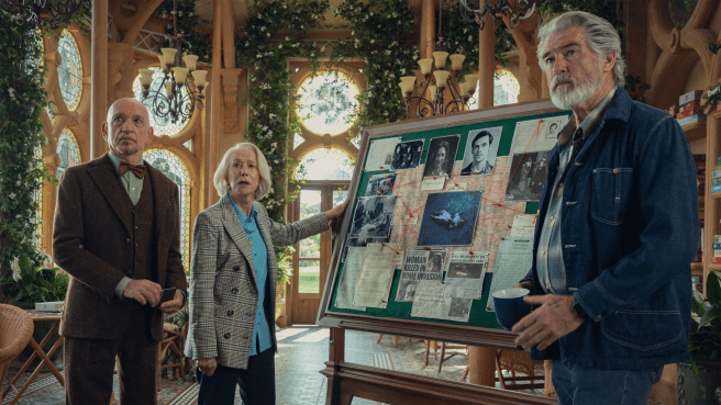 Two men (Pierce Brosnan and Ben Kingsley) and a woman (Helen Mirren) standing next to a murder board, scene from The Thursday Murder Club (2025)