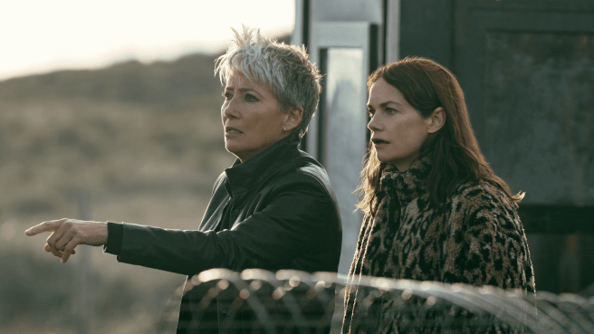Emma Thompson as Zoe Boehm and Ruth Wilson as Sarah Trafford outdoors with a fence in the foreground
