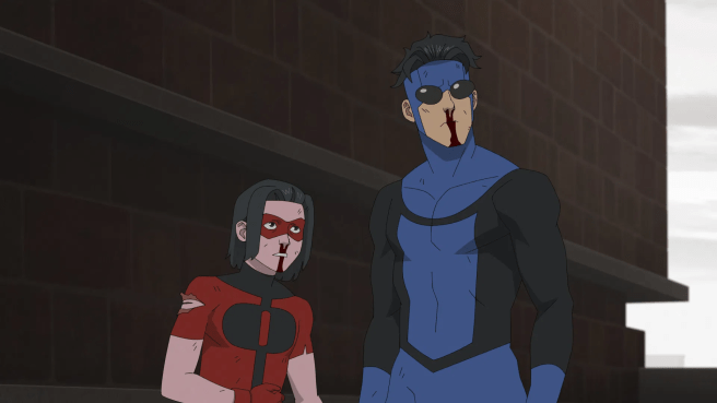 Mark and Oliver stand with bloody noses and torn clothing in front of a brick building in Invincible season 4