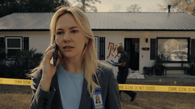 Adelaide Clemens as Catherine Delacroix in RJ Decker season 1 is talking on a smartphone in front of a house taped off with yellow "CRIME SCENE DO NOT CROSS" tape.