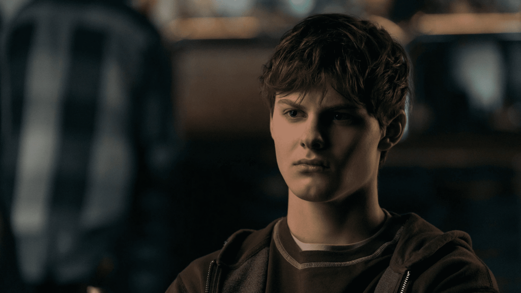 Close-up of a Cameron Crovetti as Ryan, looking off to the side with a serious expression, wearing a hooded sweatshirt in The Boys season 5.
