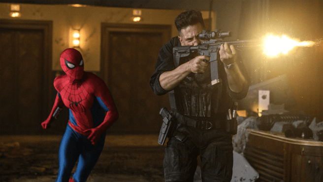 Spider-Man in a red and blue suit stands to the left of The Punisher in tactical gear firing a rifle, with a muzzle flash illuminating the scene.